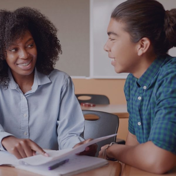 male student getting help from his teacher